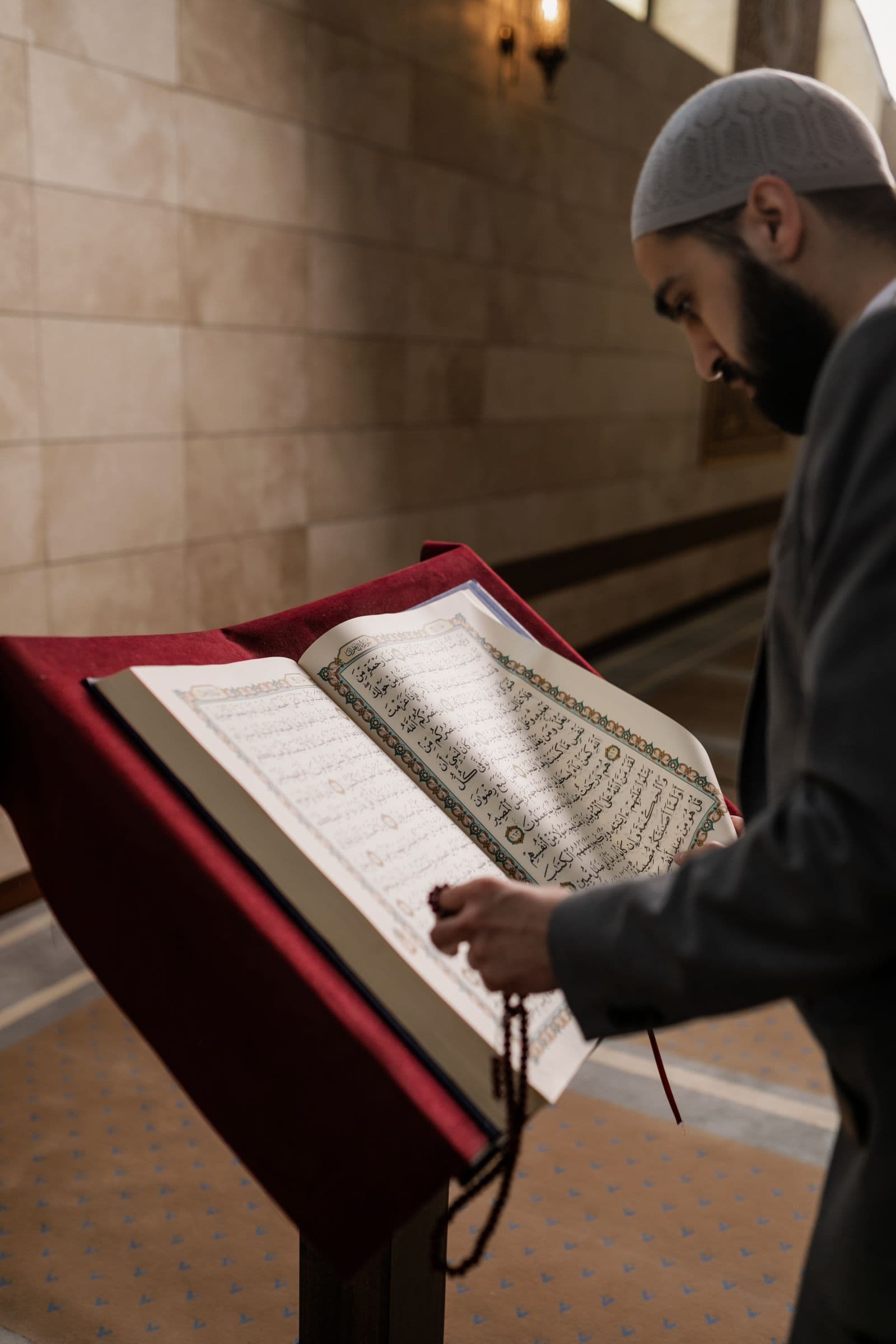 A man reading the Quran inside a mosque